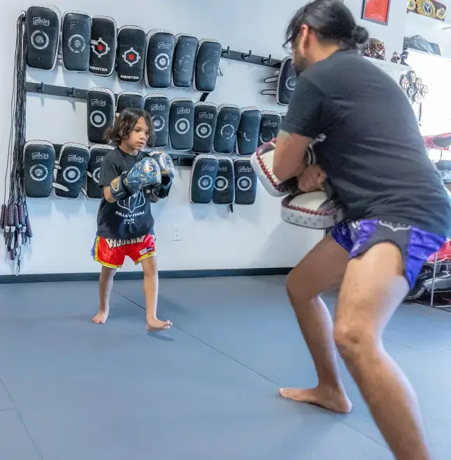 children practicing kids martial arts benefits in a dojo