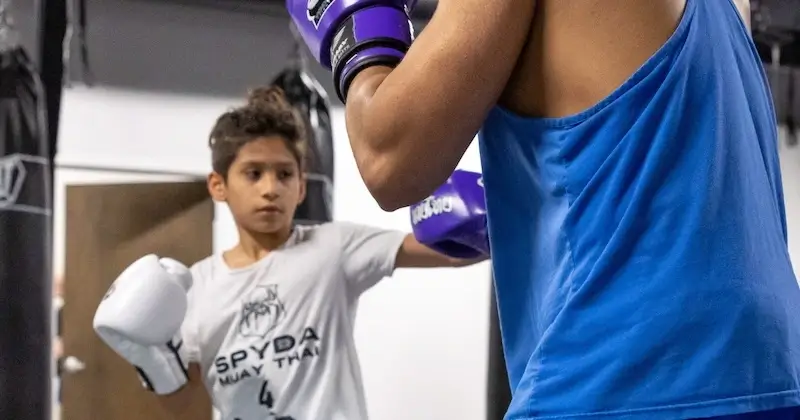 Kids engaging in muay thai training not only improve their self-defense and martial arts skills but also enhance their mental health and focus over longer periods, striving to become the best version of themselves