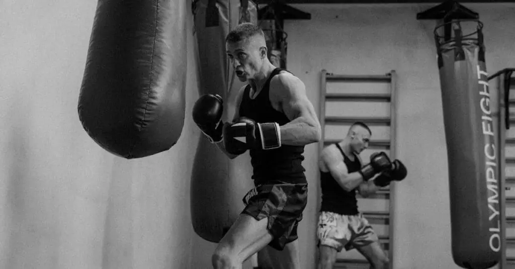 Adult martial artist practicing heavy bag drills during gym training as part of a martial arts training routine for adults