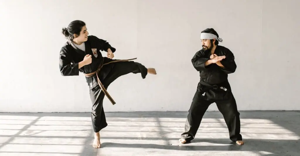 Adult students practicing controlled sparring in a structured martial arts training routine for adults