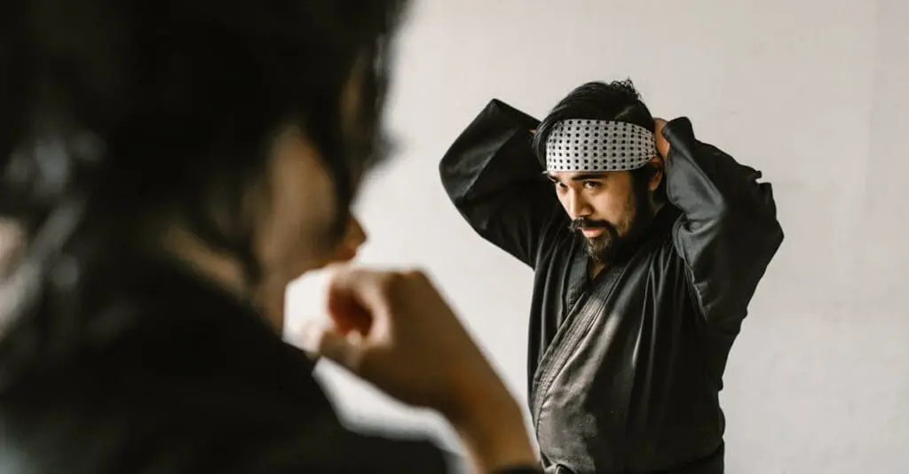 Adult martial arts participant preparing for class as part of a martial arts training routine for adults